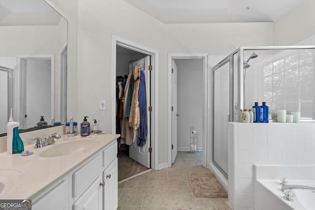 bathroom with plus walk in shower, tile patterned flooring, and vanity