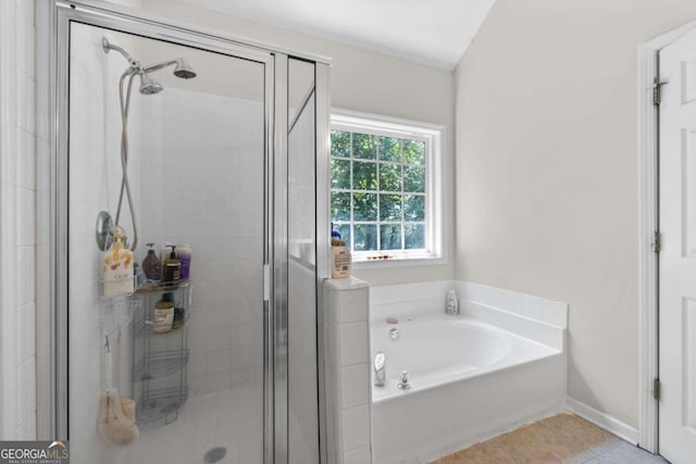 bathroom featuring shower with separate bathtub and tile patterned flooring