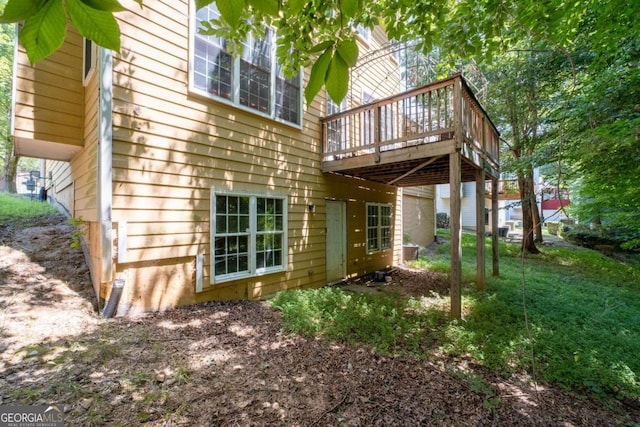 back of house featuring a wooden deck