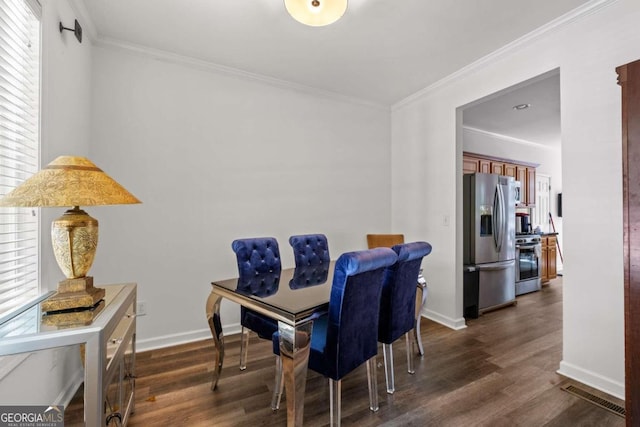 dining space with dark hardwood / wood-style flooring, plenty of natural light, and ornamental molding