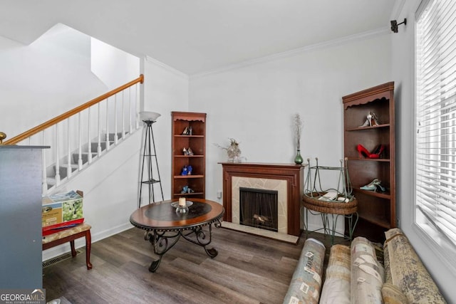 living room featuring plenty of natural light, crown molding, and dark wood-type flooring