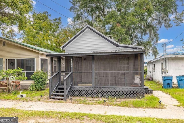 bungalow-style home with a sunroom