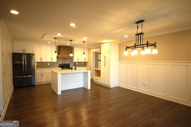 kitchen with premium range hood, black fridge with ice dispenser, decorative light fixtures, range with electric cooktop, and white cabinets