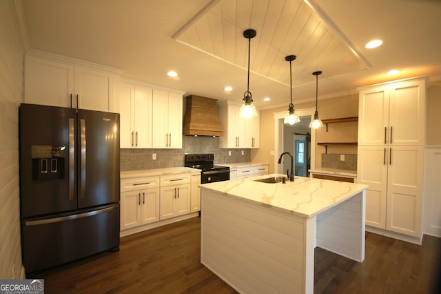 kitchen featuring black appliances, custom range hood, pendant lighting, light stone countertops, and white cabinets