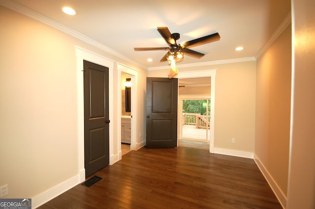 unfurnished room with crown molding, dark wood-type flooring, and ceiling fan