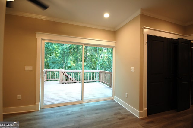 entryway with hardwood / wood-style flooring and crown molding