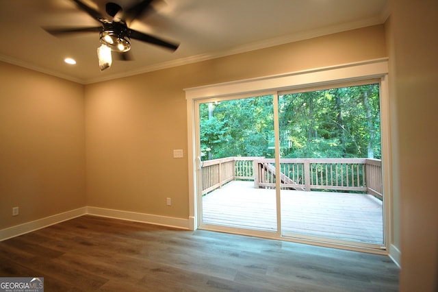 entryway with crown molding, dark wood-type flooring, and ceiling fan