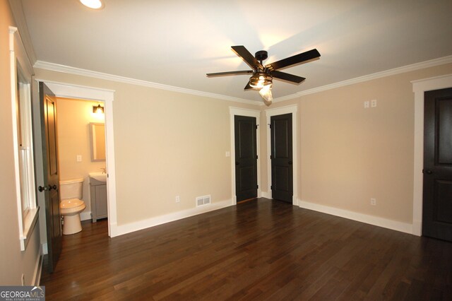 unfurnished bedroom with crown molding, ensuite bath, and dark hardwood / wood-style floors