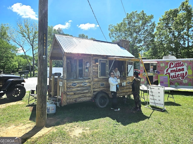 rear view of house featuring a yard