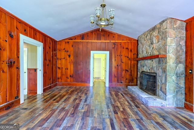 unfurnished living room featuring wood walls, vaulted ceiling, hardwood / wood-style flooring, and a fireplace