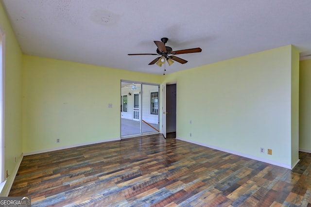 empty room with ceiling fan and dark wood-type flooring