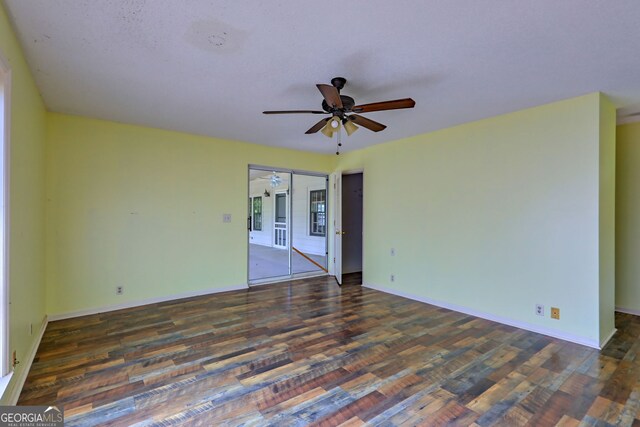 unfurnished room featuring ceiling fan, wood finished floors, and baseboards