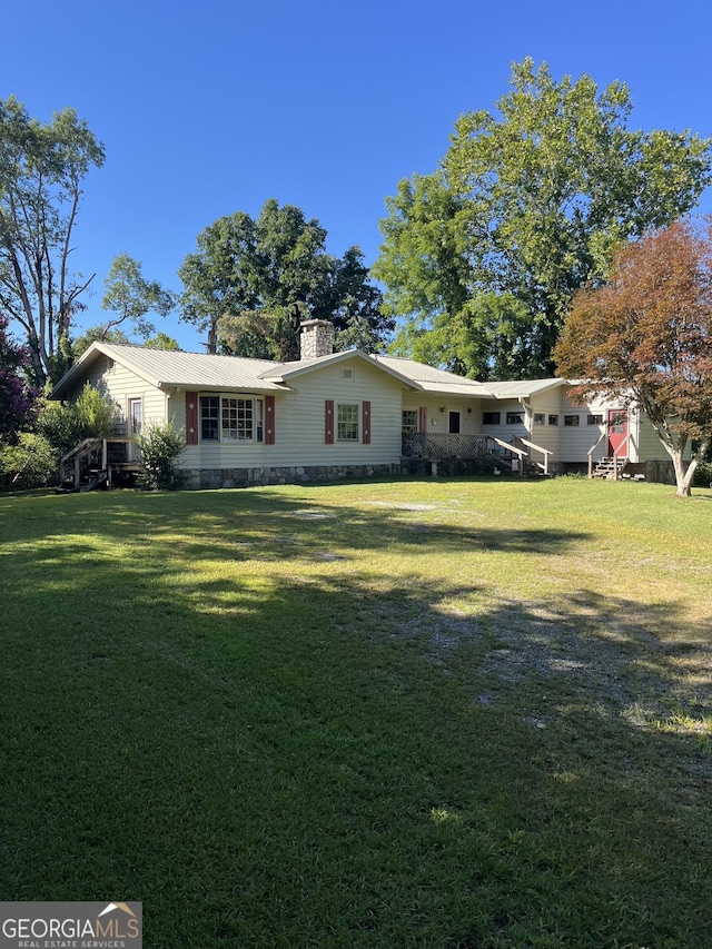 exterior space with a yard and a chimney