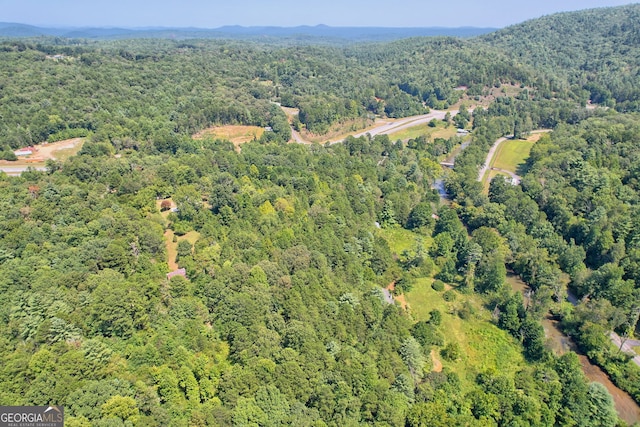 aerial view featuring a wooded view