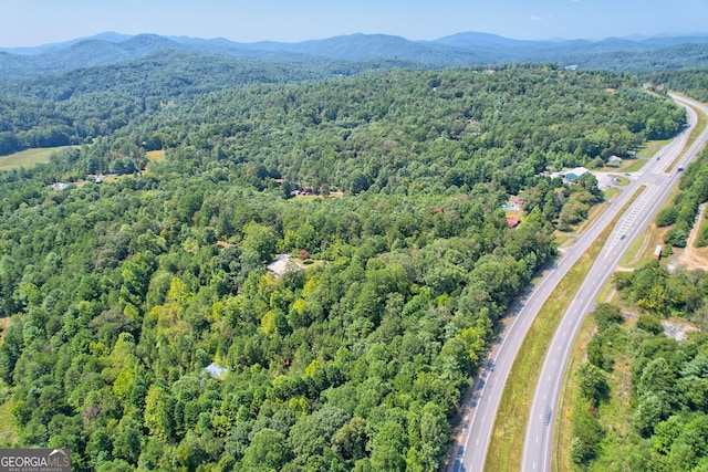 bird's eye view with a forest view and a mountain view