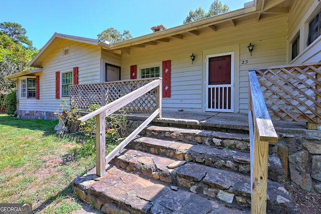 doorway to property featuring covered porch