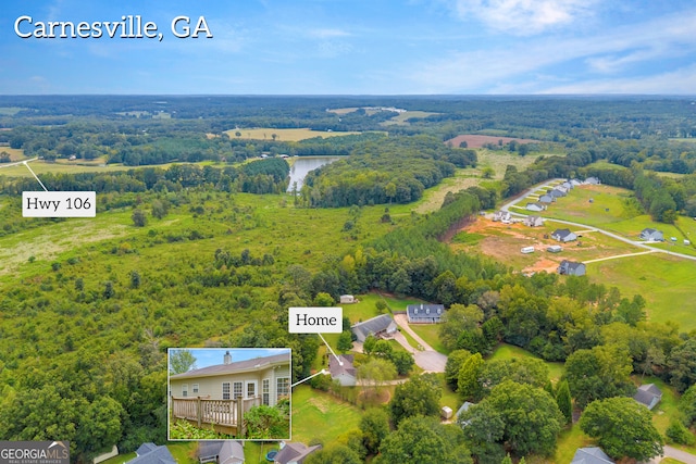 bird's eye view with a wooded view