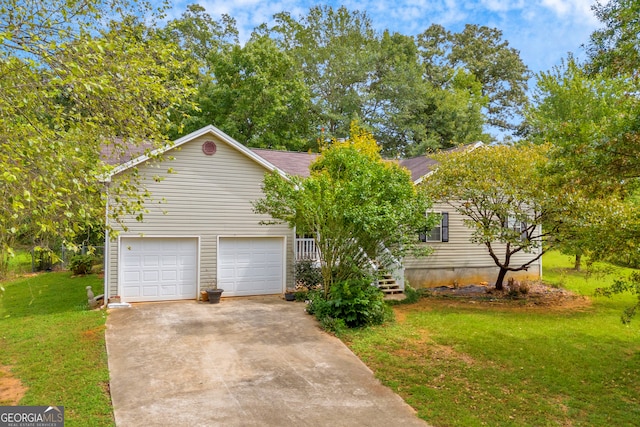 view of front of property with a front yard and a garage