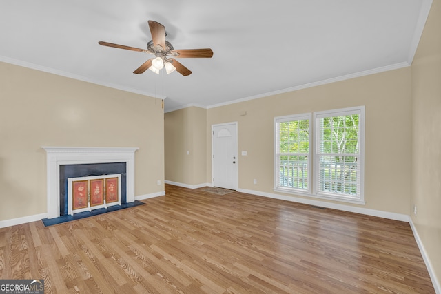 unfurnished living room with ceiling fan, ornamental molding, and light hardwood / wood-style flooring