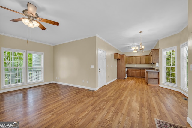 unfurnished living room featuring light hardwood / wood-style flooring, ceiling fan with notable chandelier, plenty of natural light, and crown molding