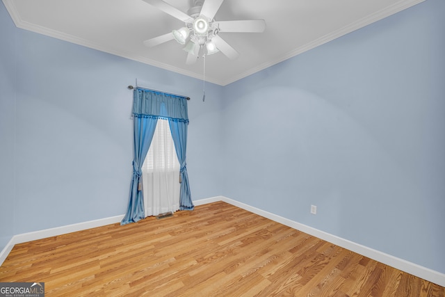 unfurnished room with ornamental molding, baseboards, ceiling fan, and light wood finished floors