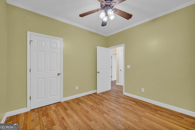 unfurnished bedroom featuring light hardwood / wood-style floors, ornamental molding, and ceiling fan