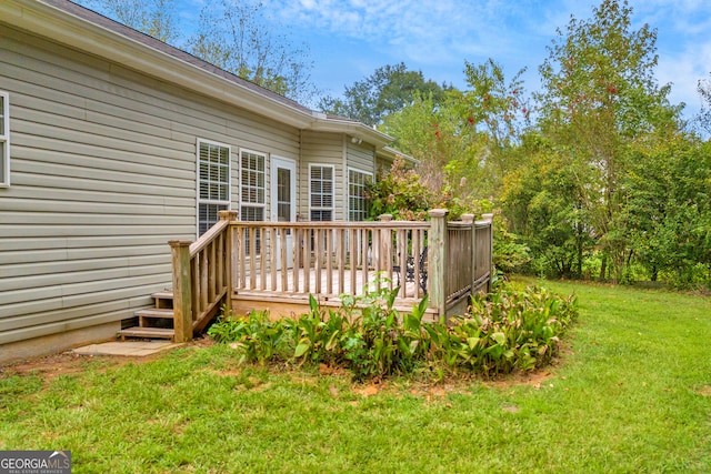 wooden deck featuring a lawn