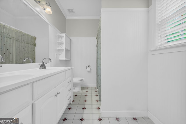 bathroom with vanity, crown molding, and toilet