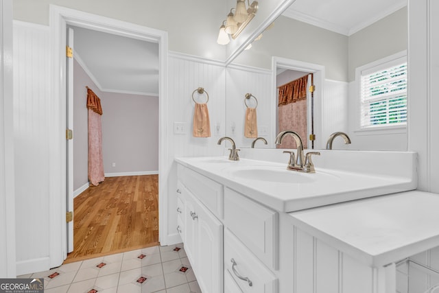 bathroom with vanity, crown molding, and wood-type flooring