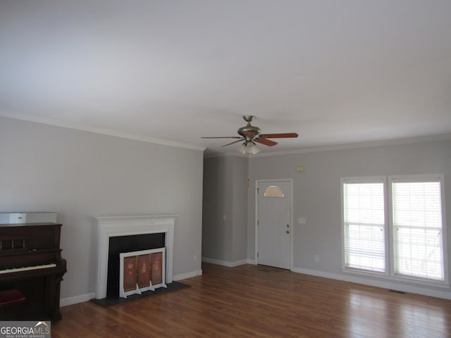 unfurnished living room featuring crown molding, visible vents, a fireplace with flush hearth, wood finished floors, and baseboards