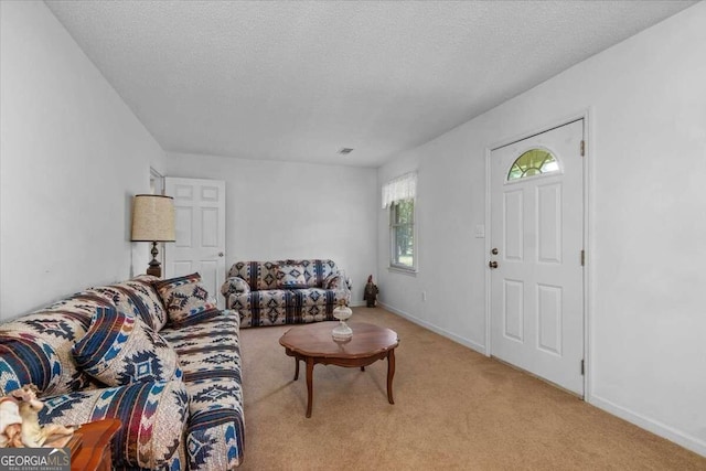 living room featuring light carpet and a textured ceiling