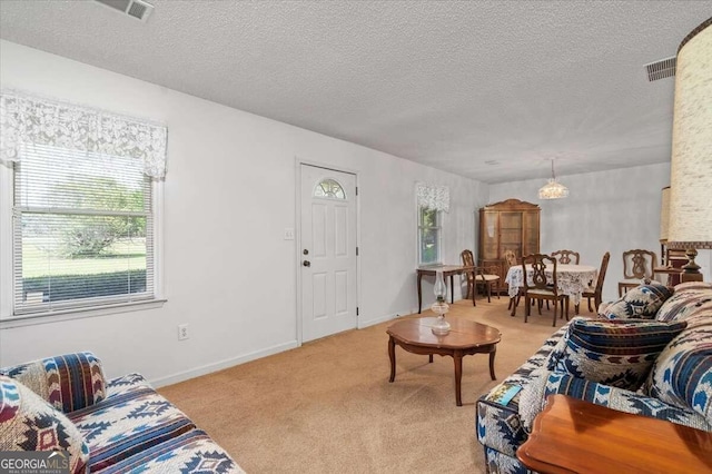 living room featuring light carpet and a textured ceiling