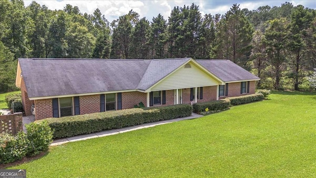 single story home featuring brick siding and a front yard