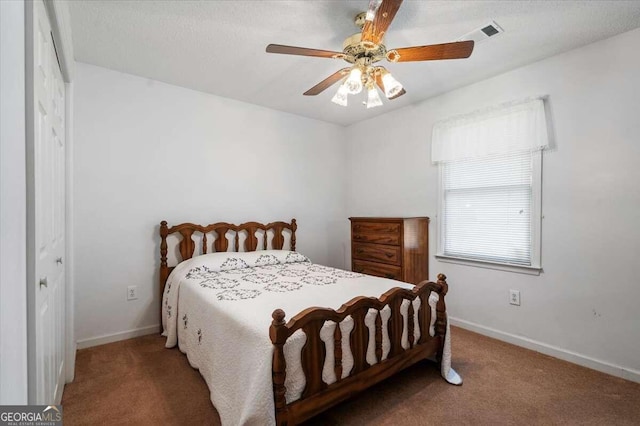 carpeted bedroom featuring ceiling fan and a closet