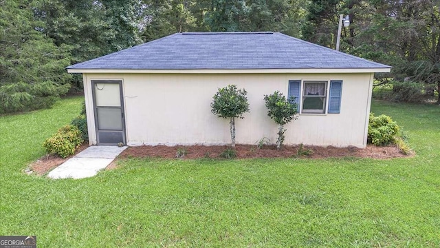 view of outbuilding with a lawn