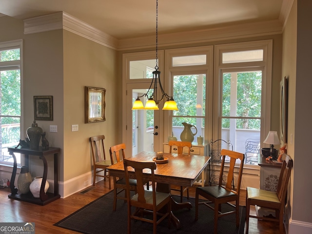 dining space featuring hardwood / wood-style flooring, plenty of natural light, and ornamental molding