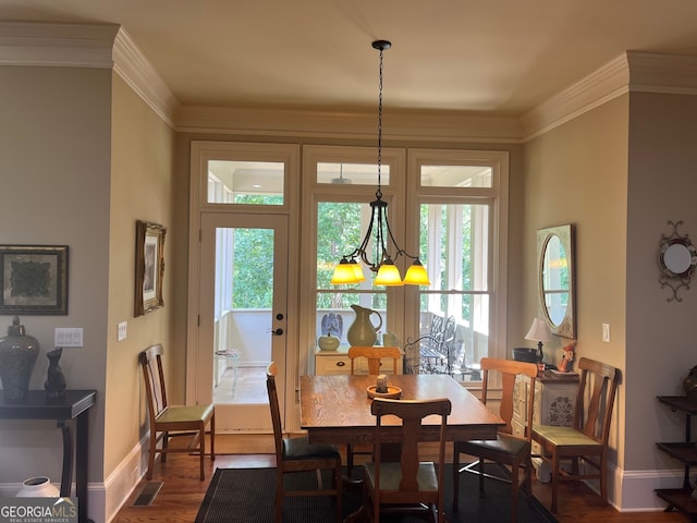 dining room featuring ornamental molding and wood-type flooring