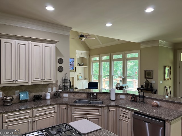 kitchen with dishwasher, decorative backsplash, sink, dark stone counters, and ceiling fan