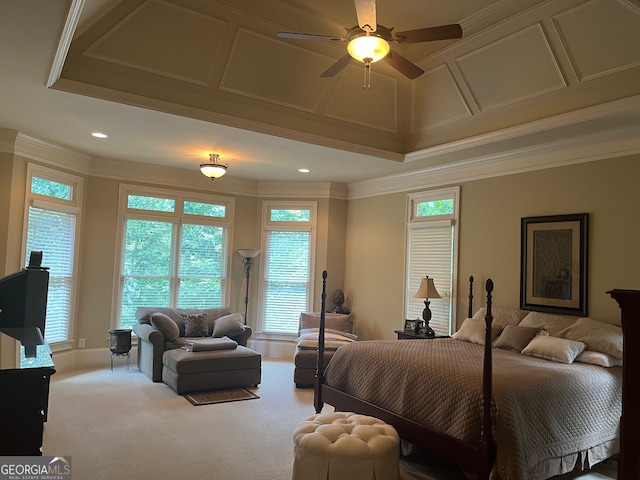 carpeted bedroom featuring ceiling fan, a raised ceiling, and ornamental molding