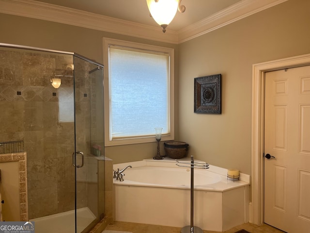 bathroom with ornamental molding and separate shower and tub