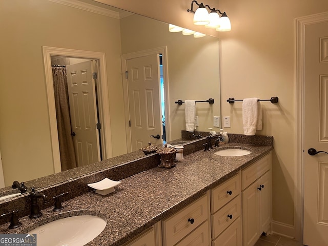 bathroom featuring ornamental molding and double sink vanity