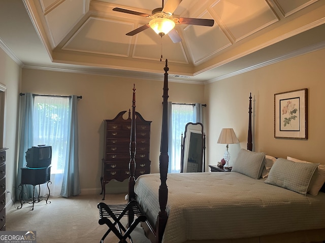 carpeted bedroom with multiple windows, crown molding, a tray ceiling, and ceiling fan