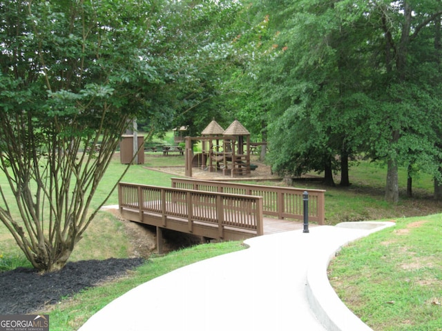 view of home's community with a lawn, a gazebo, and a wooden deck