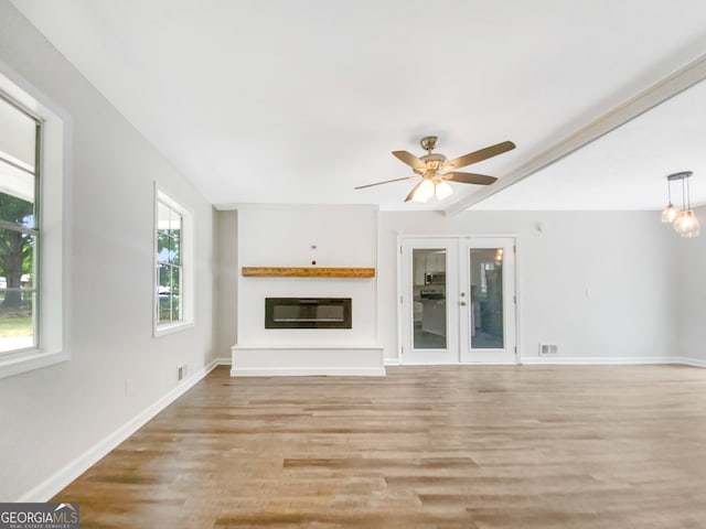 unfurnished living room featuring ceiling fan and light hardwood / wood-style flooring