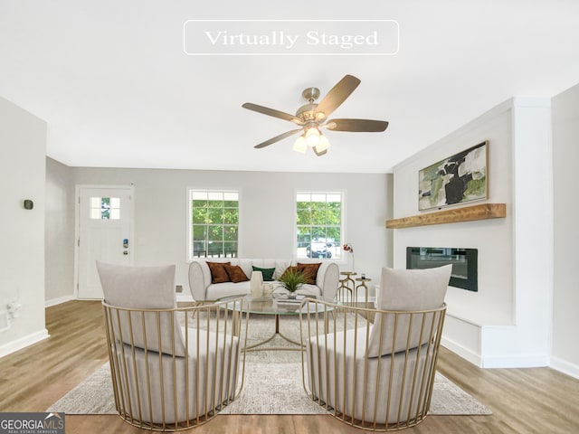 living room featuring light wood-type flooring and ceiling fan