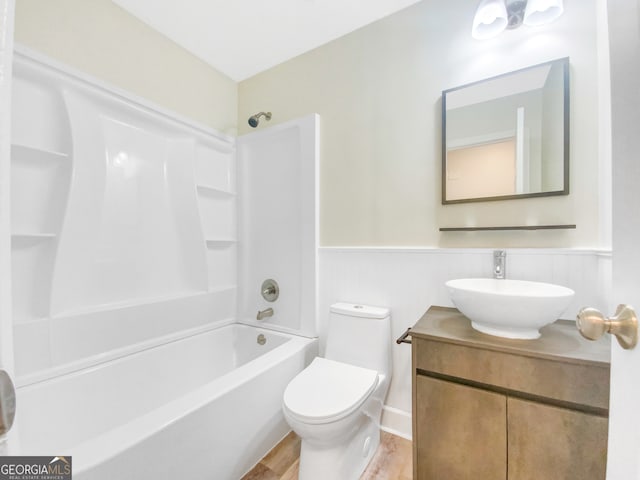 full bathroom featuring hardwood / wood-style flooring, shower / bathtub combination, toilet, and vanity