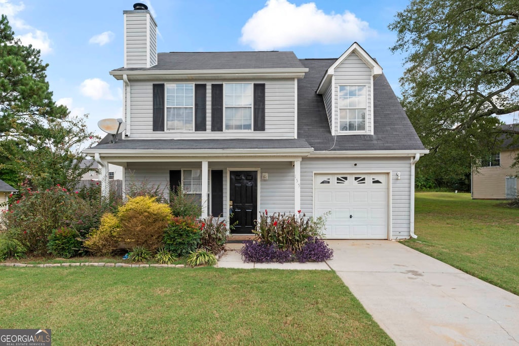 view of front of home featuring a garage, a porch, and a front lawn