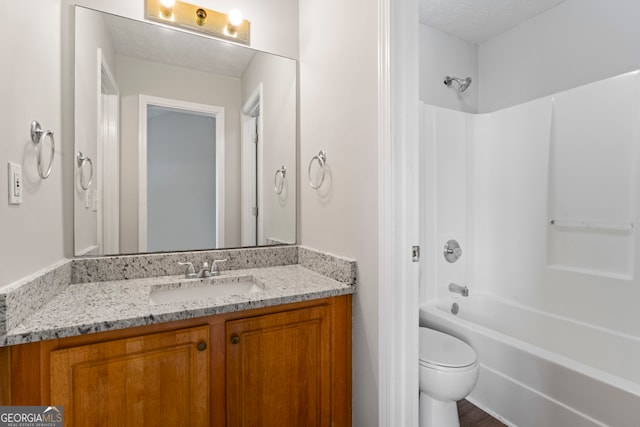 full bathroom with vanity, a textured ceiling, wood-type flooring, toilet, and  shower combination