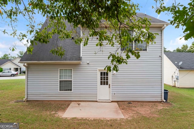 back of house featuring a patio area and a yard