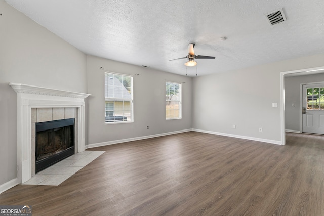 unfurnished living room featuring ceiling fan, hardwood / wood-style flooring, and a healthy amount of sunlight